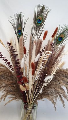 a vase filled with lots of feathers on top of a table