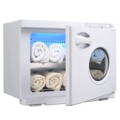 a white microwave oven with towels in it