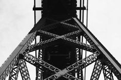 an airplane flying over the top of a tall tower with lots of metal bars on it's sides