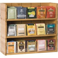 a wooden shelf filled with lots of different types of teas and coffee bags on it