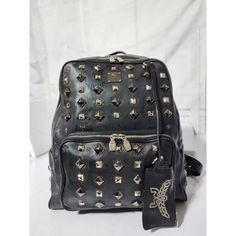 This Authentic Mcm Honshu Tantris Studded Backpack Black Is In It’s Pre-Owned Condition. The Exterior Is Clean And Beautiful. Interior Is Clean. Silver Hardware. Kindly Note That Picture On Mannequin Is Not Ours But For Size Reference And Fit. Dimensions Shoulder Strap Length: 18" Handle Drop: 1" Height: 15" Width: 14" Depth: 5" Luxury Leather Rectangular Backpack, Luxury Rectangular Leather Backpack, Designer Bags With Gunmetal Hardware, Luxury Black Leather Rectangular Backpack, Designer Black Leather Rectangular Backpack, Luxury Leather Backpack With Removable Pouch, Designer Black Rectangular Leather Backpack, Designer Standard Backpack With Branded Hardware, Luxury Standard Backpack With Branded Hardware