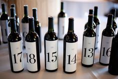 several bottles of wine sitting on top of a table next to each other with numbers on them