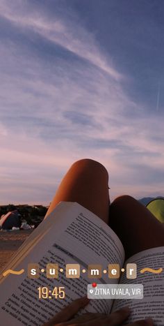 someone is reading a book on the beach