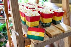 popcorn buckets with the colors of the flag of south africa are on display at an outdoor market