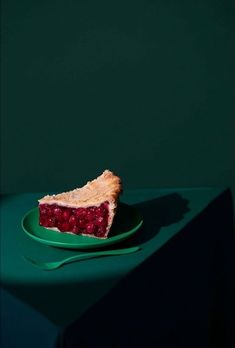 a piece of pie sitting on top of a green plate