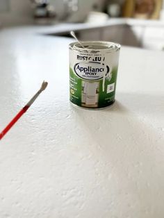 a can of paint sitting on top of a white counter