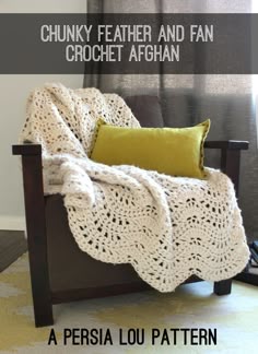 a crocheted blanket sitting on top of a wooden chair