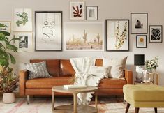 a living room filled with furniture and pictures on the wall