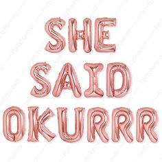 the words she said okurrr are shown in pink foil letters on a white background