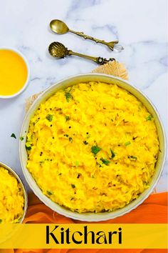 two bowls filled with yellow rice next to spoons