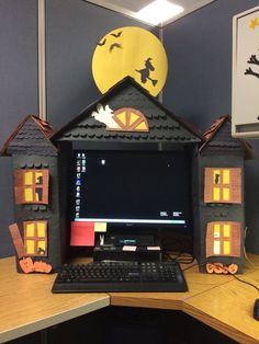 a desk with a computer on top of it and some decorations around the monitor screen