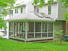 a house with a screened in porch and patio