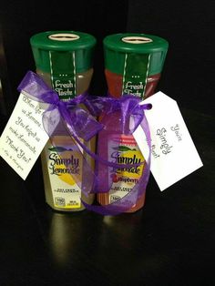 two jars of jam are wrapped in purple ribbon and labeled with the name simply lemonade