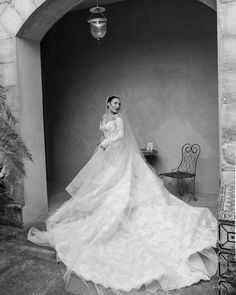 a woman in a wedding dress is posing for the camera with her veil blowing back