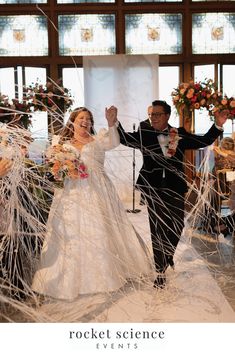 a bride and groom walk down the aisle after their wedding ceremony at rocket science