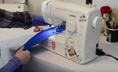 a person using a sewing machine to sew something