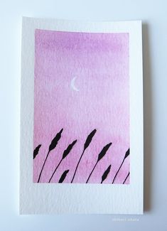 a pink sky with some black plants and a half moon