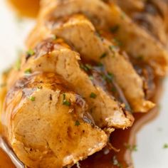 a close up of food on a plate with gravy