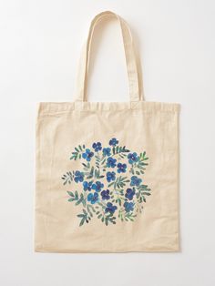 a tote bag with blue flowers painted on it