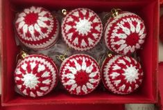 red and white crocheted ornaments in a box