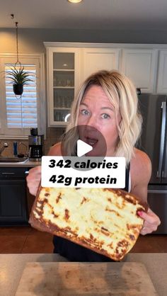 a woman holding up a piece of pizza in front of her face with the words 34 calories 42 protein written on it