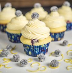 cupcakes with white frosting and silver decorations