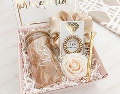 a pink box with some items in it and a notepad on the side that says bridesmaid