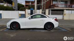 a white sports car parked in a parking lot