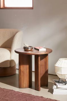 a chair and table in a room with a rug on the floor next to it