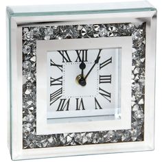 a square crystal clock with roman numerals