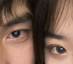 two people with blue eyes looking at the camera