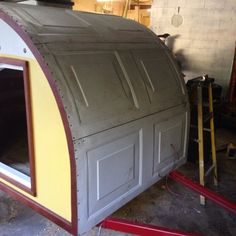 the inside of a small building being built with wood and metal trimmings on it