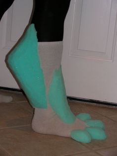 a person standing next to a door with their feet on the floor wearing socks and slippers