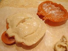 two pastries sitting on top of a table next to each other with icing