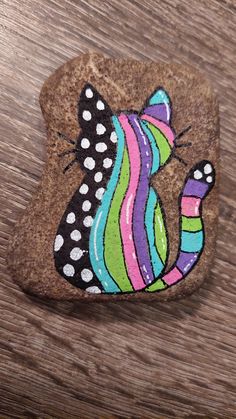 a rock with a cat painted on it