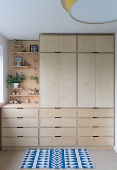 a room with wooden cabinets and rug on the floor