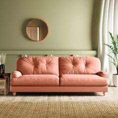 a living room with an orange couch and potted plant on the side table in front of it