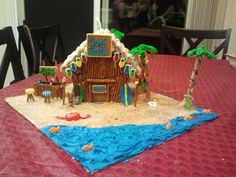 a gingerbread house made to look like it is in the sand on a table