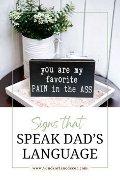 a sign that says, signs that speak dad's language on the side of a table