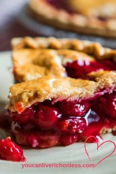 a piece of pie on a plate with cherries