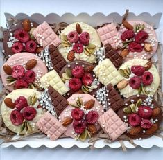 a box filled with lots of different types of desserts on top of each other