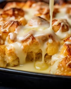 a close up of a casserole with cheese being drizzled over it