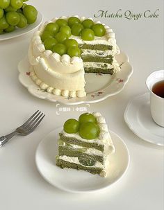 there are two pieces of cake on the plates and one piece has green grapes on it