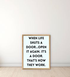 a framed poster with the words when life shuts a door open it again, it's a door that's how they work