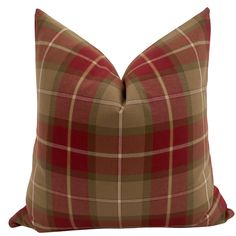 a brown and red plaid pillow on a white background