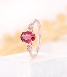 a close up of a ring with a heart shaped stone on the front and side