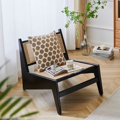 a living room scene with focus on the coffee table and chair in the foreground