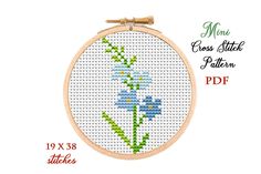 a cross stitch pattern with blue flowers in the center and text that reads mmu cross stitch pattern pdd