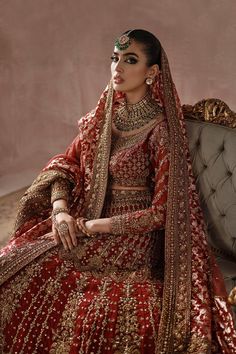 Classic Red Gold Heavily Embellished Pakistani Bridal Dress Lehenga Choli is worked in very fine Zardozi and fine gold crystals and sequins with a beautiful, traditional zari net dupatta in light red with fully embellished borders. This grand piece is more gorgeous each time. Detailed Description: SKU: BB319 Detailing: Embroidery, Motifs, Naqshi, Sequins, Dabka, Zari, Tilla, Adda work Color: Red and Gold Fabric: Jamawar, Tissue, Crimson Chiffon Design: Fully Embellished Dress with Embroidery Event: Bridal wear, Wedding Dress Lehenga, Pakistani Bridal Lehenga, Pakistani Lehenga, Pakistani Bridal Dress, Gold Crystals, Pakistani Bridal Dresses, Bridal Lehenga Choli, Pakistani Bridal Wear, Net Dupatta