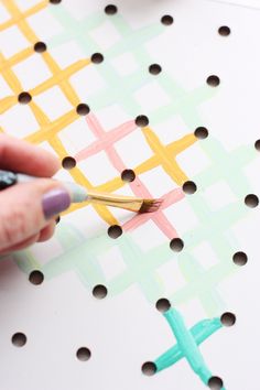 someone is painting the cross on a piece of paper with crayon pencils